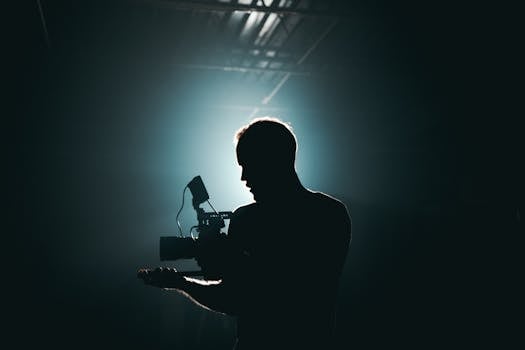 pexels-photo-3379934-3379934 Silhouette of Man Standing in Front of Microphone